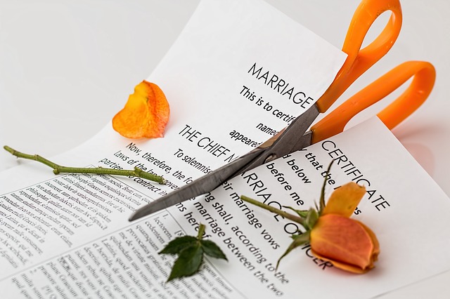 Divorce - Scissors cutting a marriage certificate