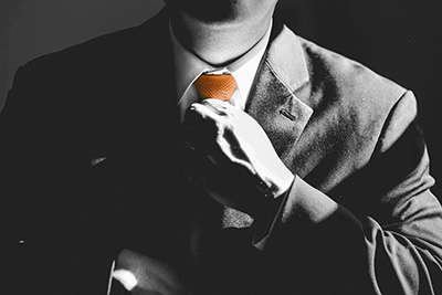 Business man in suit adjusting tie