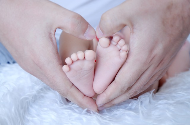 Father's hands holding baby feet