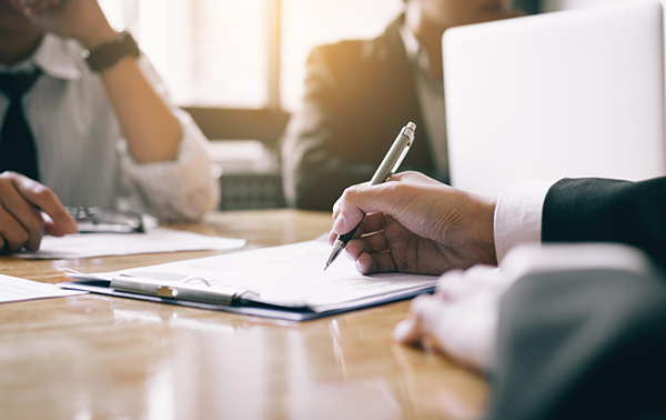 Commercial contract on a desk being signed