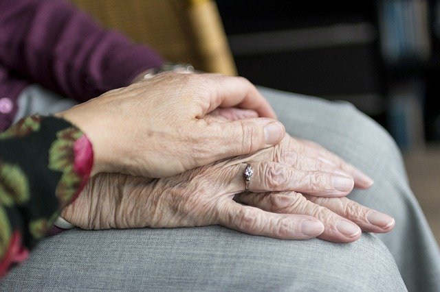 holding hands on lap