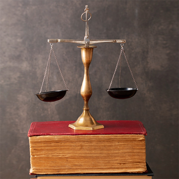 Legal justice scales resting on law books