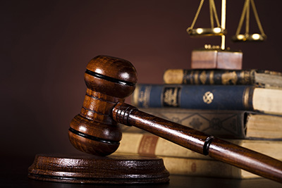 Gavel with legal books and scales