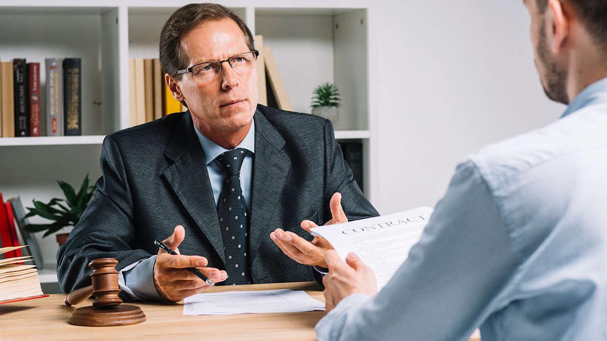 Mature Lawyer Discussing Contract With Client Courtroom