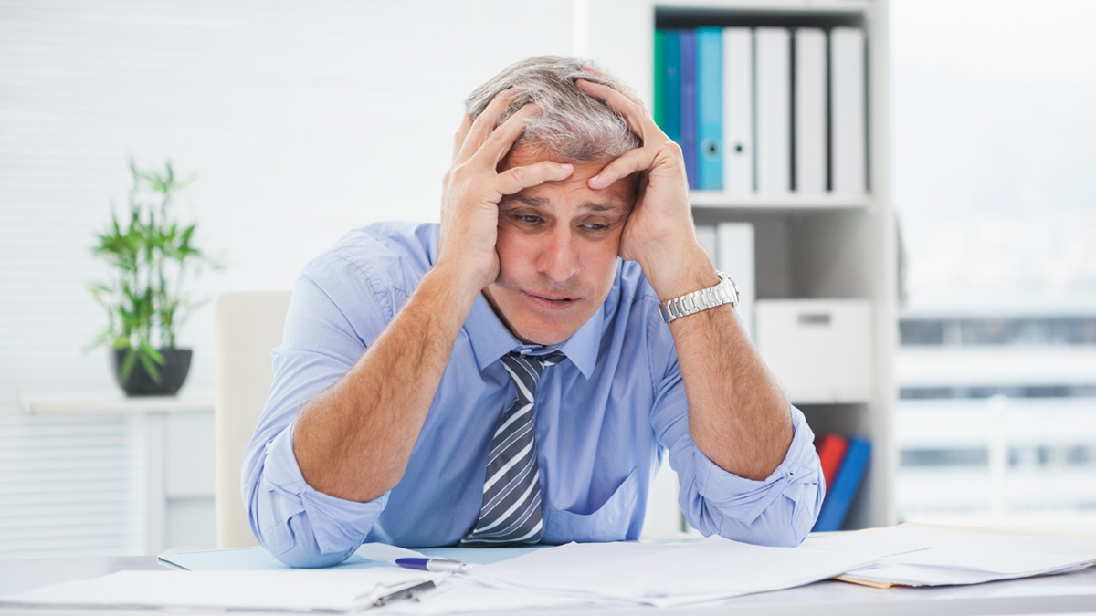 Exasperated Man At Desk
